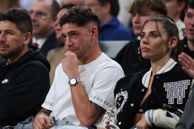 Real Madrid's Federico Valverde and Mina Bonino (R) attend the Euroleague basketball match between Real Madrid Baloncesto and Fenerbahce Beko Istanbul at Movistar Arena in Madrid on October 30, 2025. (Photo by Oscar DEL POZO / AFP)