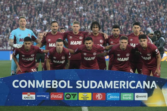 Lanus players pose for a team photo ahead of the Copa Sudamericana semifinal second leg football match between Argentina's Lanus and Chile's Universidad de Chile at the Ciudad de Lanus stadium in Lanus, Buenos Aires province, on October 30, 2025. (Photo by JUAN MABROMATA / AFP)