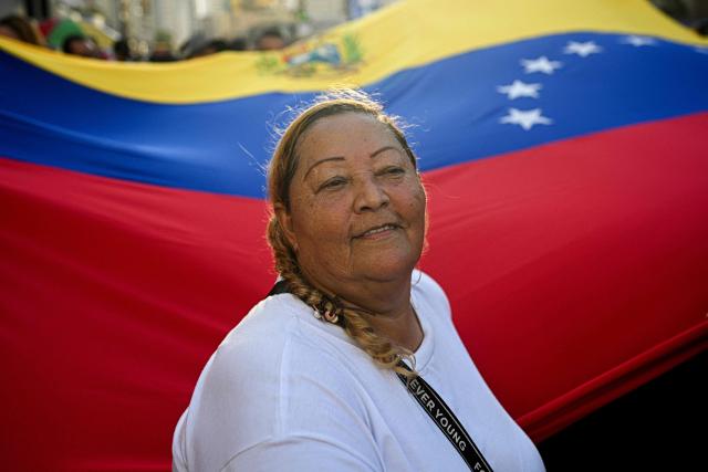 A supporter of Venezuelan President Nicolas Maduro takes part in a rally against US military activity in the Caribbean, in Caracas on October 30, 2025. A US guided-missile destroyer that docked for four days in Trinidad and Tobago, within firing range of mainland Venezuela -- which called its presence a "provocation" -- departed as scheduled on Thursday, AFP witnessed. (Photo by Federico PARRA / AFP)