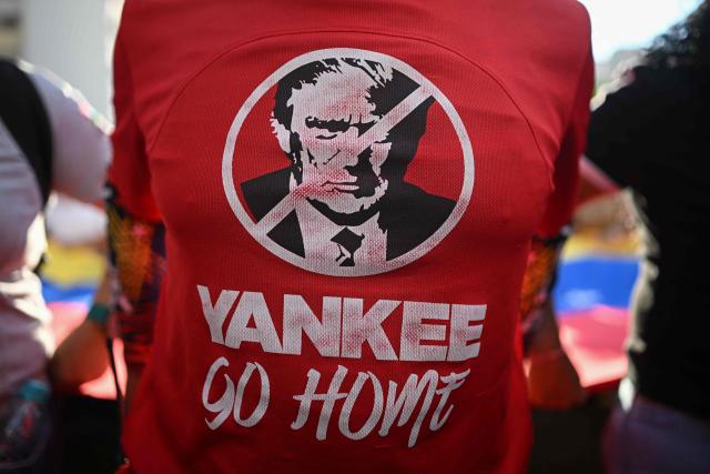 This detail view shows a t-shirt depicting US President Donald Trump and the slogan “Yankee go home” worn by a supporter of Venezuelan President Nicolas Maduro during a rally against US military activity in the Caribbean, in Caracas on October 30, 2025. A US guided-missile destroyer that docked for four days in Trinidad and Tobago, within firing range of mainland Venezuela -- which called its presence a "provocation" -- departed as scheduled on Thursday, AFP witnessed. (Photo by Federico PARRA / AFP)