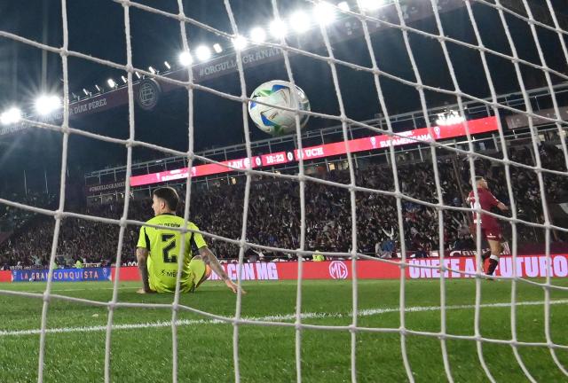 Lanus' midfielder #19 Rodrigo Castillo (R) celebrates after scoring his team's first goal past Universidad de Chile's Argentine defender #02 Franco Calderon (L) during the Copa Sudamericana semifinal second leg football match between Argentina's Lanus and Chile's Universidad de Chile at the Ciudad de Lanus stadium in Lanus, Buenos Aires province, on October 30, 2025. (Photo by Luis ROBAYO / AFP)