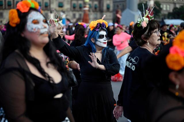 People with their faces painted as skulls participate in a Mega Aerobic Dance class ahead of the Day of the Dead at the Zocalo Square in Mexico City on October 30, 2025. (Photo by Alfredo ESTRELLA / AFP)