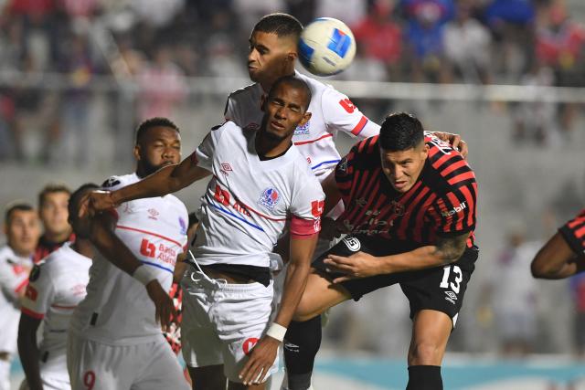Olimpia's forward #27 Jerry Bengtson and Alajuelense's defender #13 Alexis Gamboa fight for the ball during the second leg of the CONCACAF Central American Cup semifinal football match between Honduras's Olimpia and Costa Rica's Alajuelense at the National Stadium Jose de la Paz Herrera in Tegucigalpa on October 30, 2025. (Photo by Orlando SIERRA / AFP)