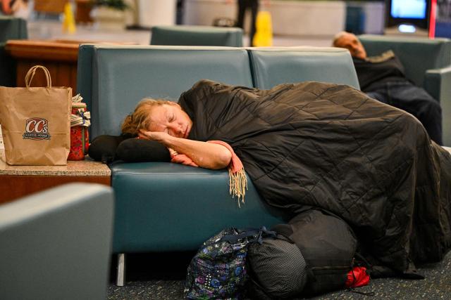 Travellers sleep on chairs at Orlando International Airport in Orlando, Florida on October 30, 2025. Flights at Orlando International Airport faced major delays on October 30, after the Federal Aviation Administration (FAA) said the airport had no certified air-traffic controllers in its tower, forcing arrivals to be halted or severely delayed amid the ongoing US government shutdown.
Air traffic controllers -- seen as "essential" public servants -- are kept at work during government shutdowns, but higher numbers are calling in sick rather than toiling without pay, leading to shortages. (Photo by Miguel J. Rodriguez Carrillo / AFP)