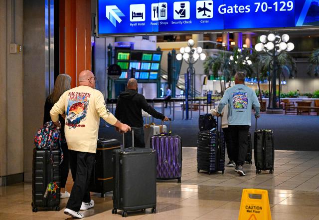 Travellers roll their suitcases as they look for a place to wait at Orlando International Airport in Orlando, Florida on October 30, 2025. Flights at Orlando International Airport faced major delays on October 30, after the Federal Aviation Administration (FAA) said the airport had no certified air-traffic controllers in its tower, forcing arrivals to be halted or severely delayed amid the ongoing US government shutdown.
Air traffic controllers -- seen as "essential" public servants -- are kept at work during government shutdowns, but higher numbers are calling in sick rather than toiling without pay, leading to shortages. (Photo by Miguel J. Rodriguez Carrillo / AFP)