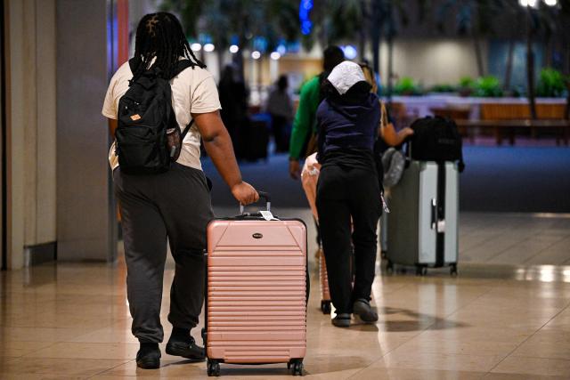 Travellers roll their suitcases as they look for a place to wait at Orlando International Airport in Orlando, Florida on October 30, 2025. Flights at Orlando International Airport faced major delays on October 30, after the Federal Aviation Administration (FAA) said the airport had no certified air-traffic controllers in its tower, forcing arrivals to be halted or severely delayed amid the ongoing US government shutdown.
Air traffic controllers -- seen as "essential" public servants -- are kept at work during government shutdowns, but higher numbers are calling in sick rather than toiling without pay, leading to shortages. (Photo by Miguel J. Rodriguez Carrillo / AFP)