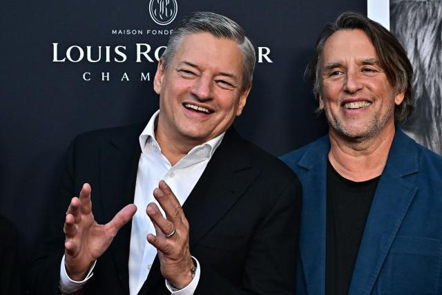 Netflix Co-CEO Ted Sarandos and US director Richard Linklater attend the premiere of Netflix’s "Nouvelle Vague" during The American French Film Festival (TAFFF) at the Directors Guild of America (DGA) Theater in Los Angeles on October 30, 2025. The 29th edition of The American French Film Festival takes place at the Directors Guild of America (DGA) from October 28 to November 3. (Photo by Frederic J. BROWN / AFP)