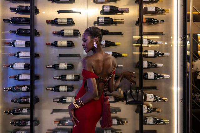 A guest poses for a photograph as she attends the Hertunba after party during Lagos Fashion Week in Lagos, on October 31, 2025. (Photo by OLYMPIA DE MAISMONT / AFP)