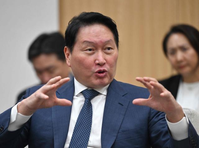 SK Group Chairman Chey Tae-won speaks during a meeting with South Korean President Lee Jae Myung and Nvidia founder and CEO Jensen Huang on the sidelines of the Asia-Pacific Economic Cooperation (APEC) summit in Gyeongju on October 31, 2025. (Photo by JUNG YEON-JE / POOL / AFP)