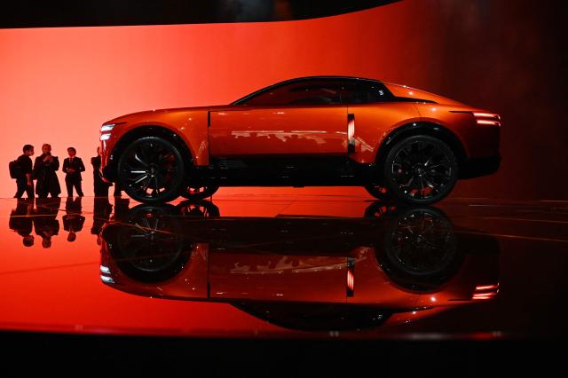 Visitors look at a Century Coupe at the Japan Mobility Show in Tokyo on October 31, 2025. (Photo by GREG BAKER / AFP)