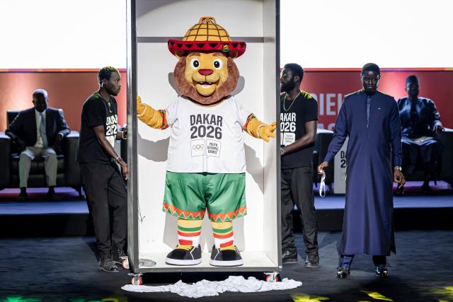 Senegal's President Bassirou Diomaye Faye (2nd R) unveils the official mascot Ayo for the Dakar 2026 Youth Olympics Games at the Grand Theatre in Dakar, on October 31, 2025. Senegal will be the first African country to host the Summer Youth Olympic Games in 2026. (Photo by PATRICK MEINHARDT / AFP)
