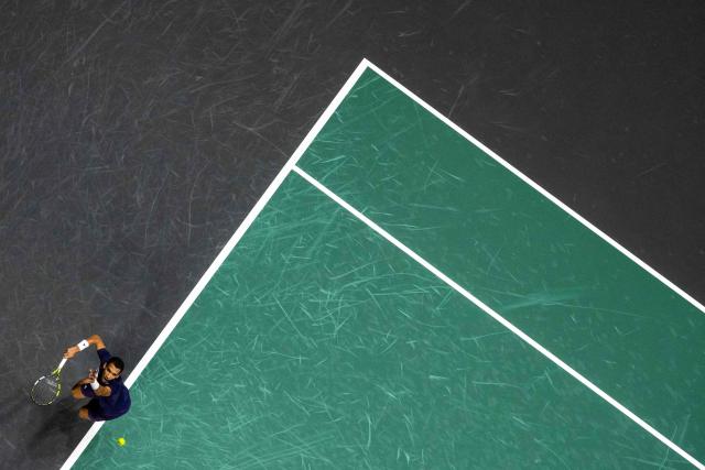 Canada's Felix Auger-Aliassime serves to Monaco's Valentin Vacherot during their men's singles quarter-final match on day five of the Paris ATP Masters 1000 tennis tournament at the Paris La Défense Arena in Nanterre, on the outskirts of Paris, on October 31, 2025. (Photo by JULIEN DE ROSA / AFP)