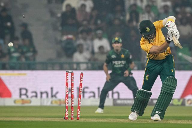 South Africa's Reeza Hendricks is clean bowled Pakistan's Salman Mirza during the second Twenty20 international cricket match between Pakistan and South Africa at Gaddafi Stadium in Lahore on October 31, 2025. (Photo by Farooq NAEEM / AFP)