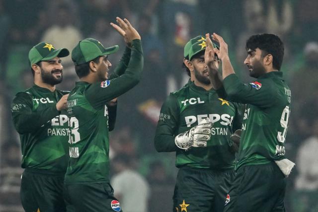 Pakistan's Salman Mirza (R) celebrates with teammates after taking the wicket of South Africa's Reeza Hendricks during the second Twenty20 international cricket match between Pakistan and South Africa at Gaddafi Stadium in Lahore on October 31, 2025. (Photo by Farooq NAEEM / AFP)