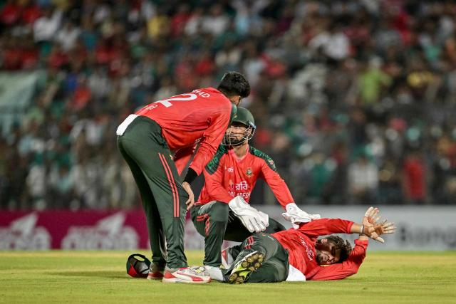 Bangladesh's Nurul Hasan (R) reacts after getting injured during the third Twenty20 international cricket match between Bangladesh and West Indies at the Bir Sreshtho Flight Lieutenant Matiur Rahman Stadium in Chittagong on October 31, 2025. (Photo by MUNIR UZ ZAMAN / AFP)