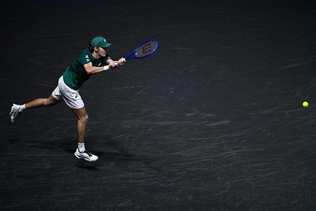 Australia's Alex De Minaur plays a backhand return to Kazakhstan's Alexander Bublik during their men's singles quarter-final match on day five of the Paris ATP Masters 1000 tennis tournament at the Paris La Défense Arena in Nanterre, on the outskirts of Paris, on October 31, 2025. (Photo by JULIEN DE ROSA / AFP)