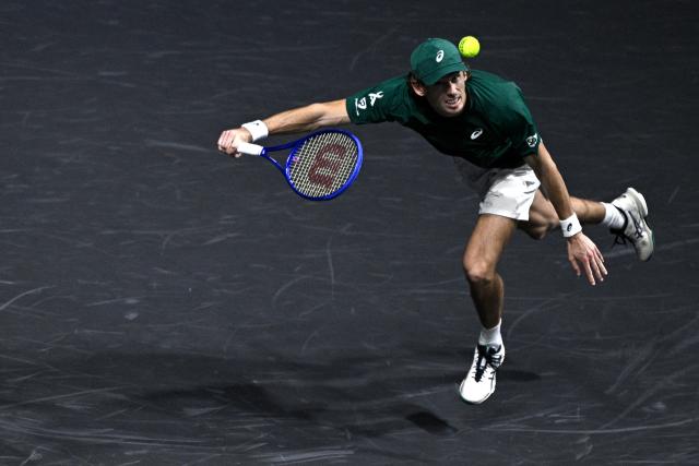 Australia's Alex De Minaur plays a forehand return to Kazakhstan's Alexander Bublik during their men's singles quarter-final match on day five of the Paris ATP Masters 1000 tennis tournament at the Paris La Défense Arena in Nanterre, on the outskirts of Paris, on October 31, 2025. (Photo by JULIEN DE ROSA / AFP)