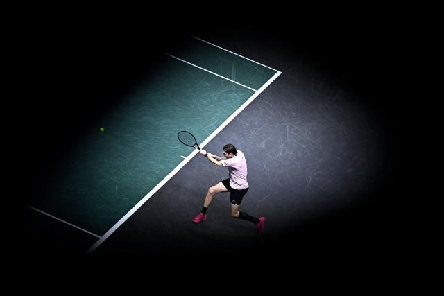 Kazakhstan's Alexander Bublik plays a backhand return to Australia's Alex De Minaur during their men's singles quarter-final match on day five of the Paris ATP Masters 1000 tennis tournament at the Paris La Défense Arena in Nanterre, on the outskirts of Paris, on October 31, 2025. (Photo by JULIEN DE ROSA / AFP)