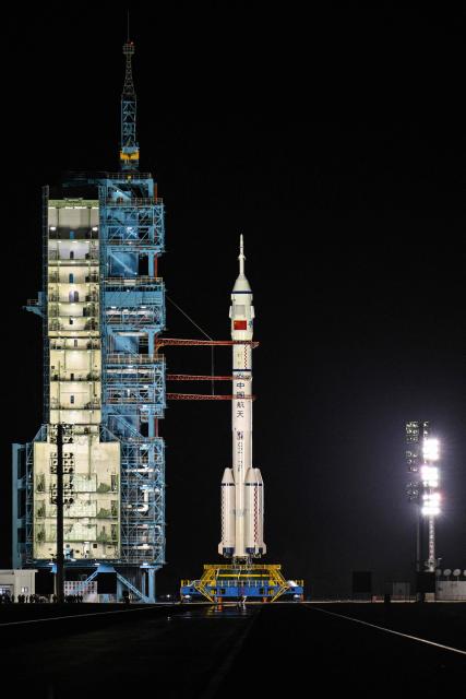 A Long March-2F carrier rocket, carrying the Shenzhou-21 spacecraft and a crew of three astronauts, sits on the launch site beofre lifting off at the Jiuquan Satellite Launch Centre in the Gobi desert, in northwest China on October 31, 2025. A new crew took off for China's Tiangong space station on October 31, including the country's youngest ever astronaut and four lab mice. (Photo by Hector RETAMAL / AFP)