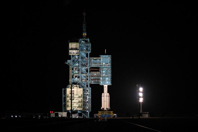 A Long March-2F carrier rocket, carrying the Shenzhou-21 spacecraft and a crew of three astronauts, sits on the launch site beofre lifting off at the Jiuquan Satellite Launch Centre in the Gobi desert, in northwest China on October 31, 2025. A new crew took off for China's Tiangong space station on October 31, including the country's youngest ever astronaut and four lab mice. (Photo by Hector RETAMAL / AFP)
