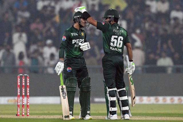 Pakistan's Babar Azam (R) celebrates with Saim Ayub after his half century (50 runs) during the second Twenty20 international cricket match between Pakistan and South Africa at the Gaddafi Cricket Stadium in Lahore on October 31, 2025. (Photo by Farooq NAEEM / AFP)