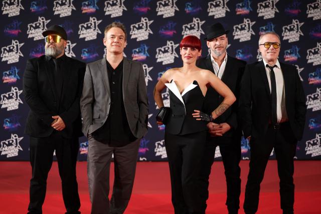 (From 2nd-L) Member of French pop rock band Superbus Patrice Focone, French singer Jennifer Ayache and Member of French pop rock band Superbus Michel Giovannetti (R) pose upon arrival on the red carpet to attend the 27th edition of the NRJ Music Awards ceremony at the Palais des Festivals, in Cannes, southeastern France, on October 31, 2025. (Photo by Valery HACHE / AFP)