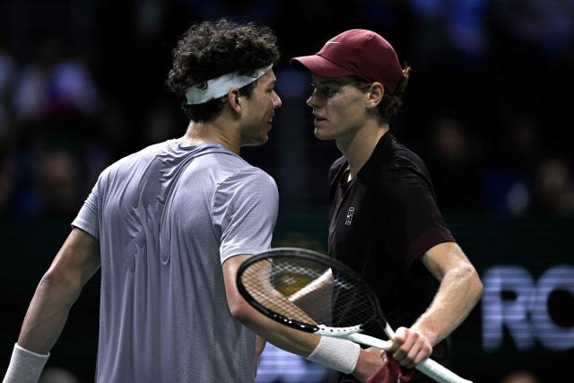 Winner Italy's Jannik Sinner (R) celebrates cheers US Ben Shelton at the end of their men's singles quarter-final match on day five of the Paris ATP Masters 1000 tennis tournament at the Paris La Défense Arena in Nanterre, on the outskirts of Paris, on October 31, 2025. (Photo by JULIEN DE ROSA / AFP)