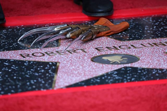 Freddy Krueger's glove is pictured over US actor Robert Englund's star during his Hollywood Walk of Fame Star ceremony in Hollywood, California on October 31, 2025. (Photo by Patrick T. Fallon / AFP)