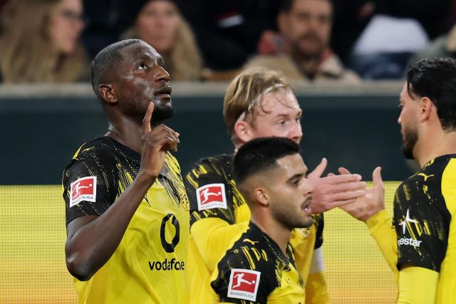 Dortmund's Guinean forward #09 Serhou Guirassy (L) celebrates scoring his team's first goal with team mates during the German first division Bundesliga football match between FC Augsburg and Borussia Dortmund in Augsburg, southern Germany on October 31, 2025. (Photo by Alexandra BEIER / AFP) / DFL REGULATIONS PROHIBIT ANY USE OF PHOTOGRAPHS AS IMAGE SEQUENCES AND/OR QUASI-VIDEO