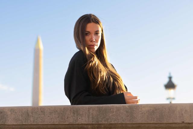 Swiss and French racing driver Laura Villars, poses in front of the FIA headquarters in Paris, on October 31, 2025. Swiss racing driver Laura Villars filed legal action on October 29, 2025 against motorsport's governing body to challenge FIA election rules, which she argues prevent her or any other candidate from running against incumbent president Mohammed Ben Sulayem. (Photo by JOEL SAGET / AFP)