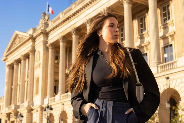Swiss and French racing driver Laura Villars, poses in front of the FIA headquarters in Paris, on October 31, 2025. Swiss racing driver Laura Villars filed legal action on October 29, 2025 against motorsport's governing body to challenge FIA election rules, which she argues prevent her or any other candidate from running against incumbent president Mohammed Ben Sulayem. (Photo by JOEL SAGET / AFP)