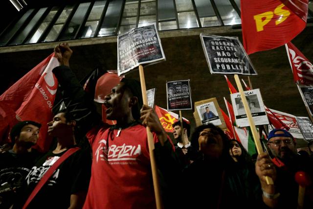 People take part in a protest in Sao Paulo, Brazil on October 31, 2025, to demand justice for victims of a massive police raid that left at least 117 suspected criminals and four police officers dead. (Photo by NELSON ALMEIDA / AFP)