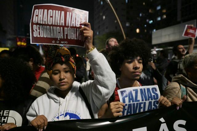 People take part in a protest in Sao Paulo, Brazil on October 31, 2025, to demand justice for victims of a massive police raid that left at least 117 suspected criminals and four police officers dead. (Photo by NELSON ALMEIDA / AFP)