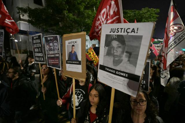 People take part in a protest in Sao Paulo, Brazil on October 31, 2025, to demand justice for victims of a massive police raid that left at least 117 suspected criminals and four police officers dead. (Photo by NELSON ALMEIDA / AFP)