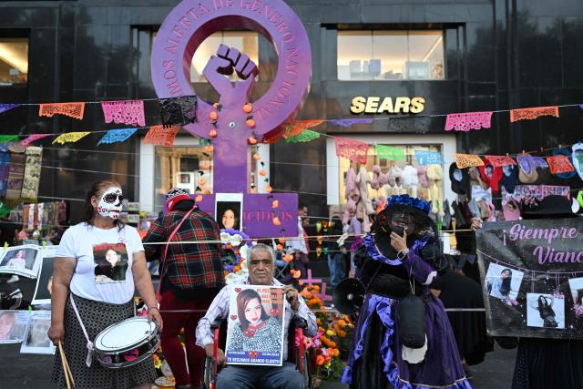 Relatives with their faces painted as "Catrina" take part in a protest march to demand the clarification of femicides ahead of the Day of the Dead celebrations in Mexico City on October 31, 2025. (Photo by Yuri CORTEZ / AFP)