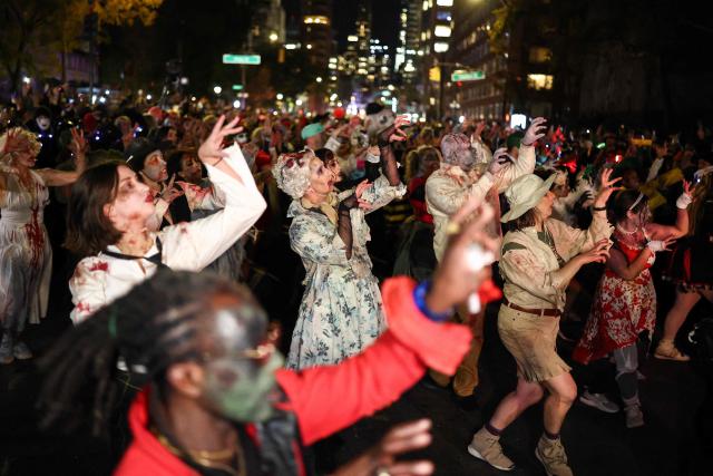 Costumed revellers take part in the Halloween parade in Manhattan, New York City, on October 31, 2025. (Photo by CHARLY TRIBALLEAU / AFP)