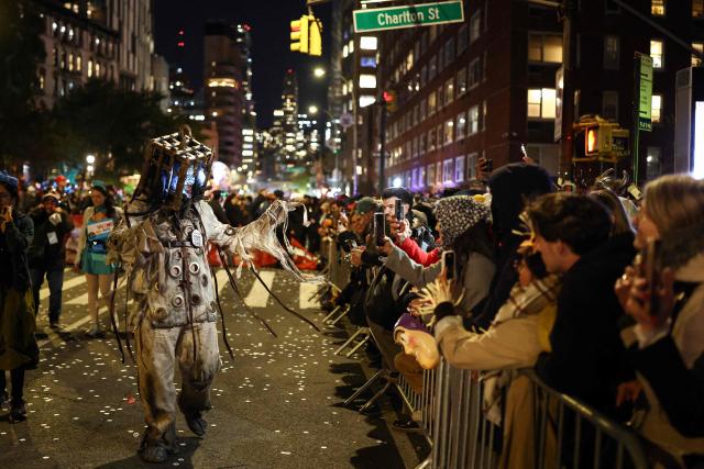 Costumed revellers take part in the Halloween parade in Manhattan, New York City, on October 31, 2025. (Photo by CHARLY TRIBALLEAU / AFP)