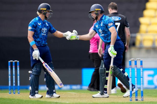 England Jos Buttler (R) bumps gloves with teammate Jacob Bethell during the 3rd ODI cricket match between New Zealand and England at Sky Stadium in Wellington on November 1, 2025. (Photo by Marty MELVILLE / AFP)
