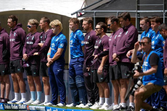 England players stand for a minute's silence for the passing of Australian teen cricketer Ben Austin who died after being hit by a ball in the nets before a local game in Melbourne, during the 3rd ODI cricket match between New Zealand and England at Sky Stadium in Wellington on November 1, 2025. (Photo by Marty MELVILLE / AFP)
