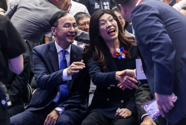 Newly elected opposition Kuomintang (KMT) leader Cheng Li-wun (R) and former KMT chairman Eric Chu (L) sit together before the Kuomintang (KMT) 12th National Congress in Taipei on November 1, 2025 (Photo by I-Hwa Cheng / AFP)