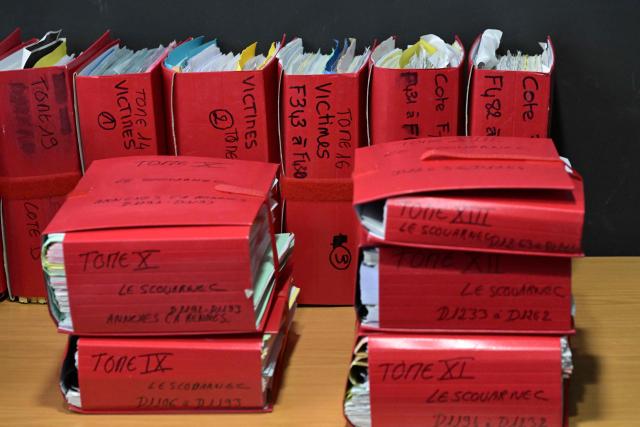 (FILES) This photograph shows files in the courtroom of the Criminal Court in Vannes, on February 24, 2025, on the opening day of retired surgeon Joel Le Scouarnec's four-month trial on charges of assaulting or raping 299 patients. After his sentencing to 20 years in prison at the end of May, the judiciary is once again examining on November 3, 2025 the crimes committed by Joel Le Scouarnec, this time to assess the impact of the sexual violence on his hundreds of victims in order to compensate them. The total amounts of these damages and interests are expected to reach several hundred thousand euros. (Photo by Damien MEYER / AFP)