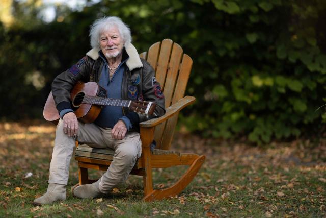 (FILES) French singer, songwriter, and composer Hugues Aufray plays the guitar in his garden at the former house of the French-Catalan artist Aristide Maillol, in Marly-le-Roi near Paris, on October 14, 2025. "Santiano", "Céline", "Stewball"...: crowned with timeless successes, including adaptations of his friend Bob Dylan's songs, Hugues Aufray, a guiding figure in Francophone music, continues his journey with undiminished energy and embarks on a new tour at the age of 96. (Photo by JOEL SAGET / AFP)