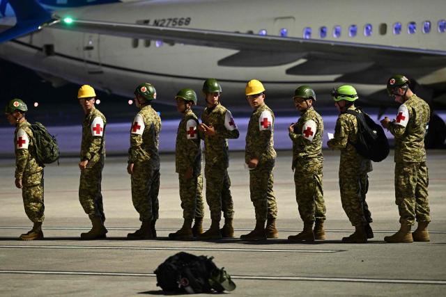 Salvadorean soldiers board a plane with humanitarian aid bound for Jamaica, ordered by El Salvador's President Nayib Bukele, after the passage of Hurricane Melissa, at the tarmac of San Oscar Romero International Airport in San Luis Talpa, El Salvador on October 31, 2025. Melissa, the worst Atlantic hurricane in nearly a century, left at least 30 dead in Haiti and 19 in Jamaica, as well as parts of Cuba in ruins, as it moved through the Caribbean toward Bermuda on Thursday. (Photo by Marvin RECINOS / AFP)