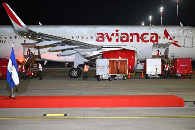 Airport workers load a plane with humanitarian aid bound for Jamaica, ordered by El Salvador's President Nayib Bukele, after the passage of Hurricane Melissa, at the tarmac of San Oscar Romero International Airport in San Luis Talpa, El Salvador on October 31, 2025. Melissa, the worst Atlantic hurricane in nearly a century, left at least 30 dead in Haiti and 19 in Jamaica, as well as parts of Cuba in ruins, as it moved through the Caribbean toward Bermuda on Thursday. (Photo by Marvin RECINOS / AFP)