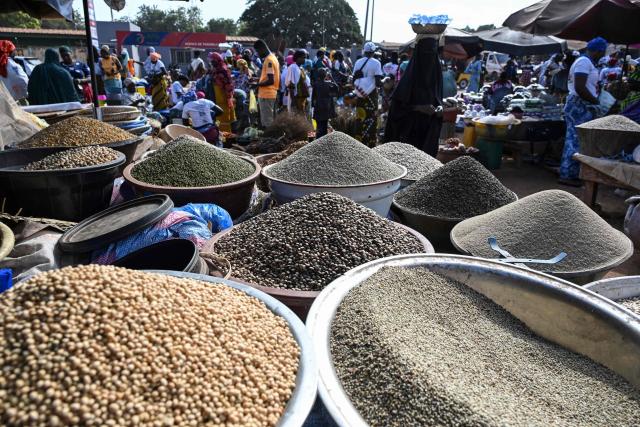 Goods are sold at a market in Tengrela, northern Ivory Coast near the Mali border, on October 31, 2025. (Photo by Issouf SANOGO / AFP)
