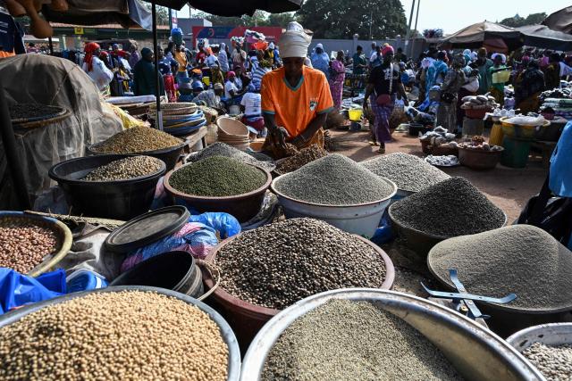 Goods are sold at a market in Tengrela, northern Ivory Coast near the Mali border, on October 31, 2025. (Photo by Issouf SANOGO / AFP)