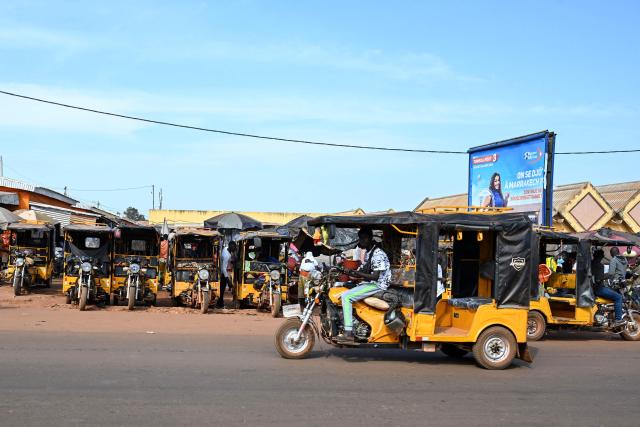 A general view of a tricycle in a street in Tengrela, northern Ivory Coast near the Mali border, on October 31, 2025. (Photo by Issouf SANOGO / AFP)