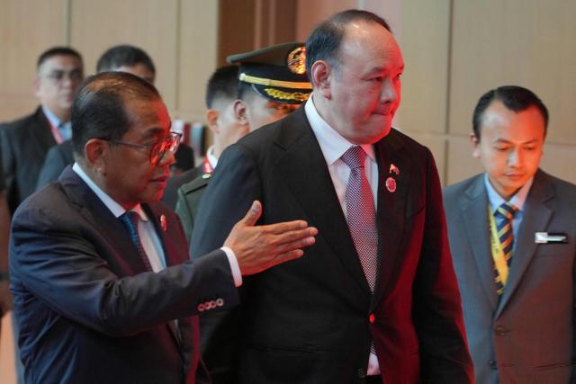 Malaysia's Defence Minister Mohamed Khaled Nordin (L) shows the way to Philippines Defence Secretary Gilberto Teodoro as they attend a ministerial lunch at the Association of Southeast Asian Nations (ASEAN) Defence Ministers' Meeting in Kuala Lumpur on November 1, 2025. (Photo by Dita ALANGKARA / POOL / AFP)