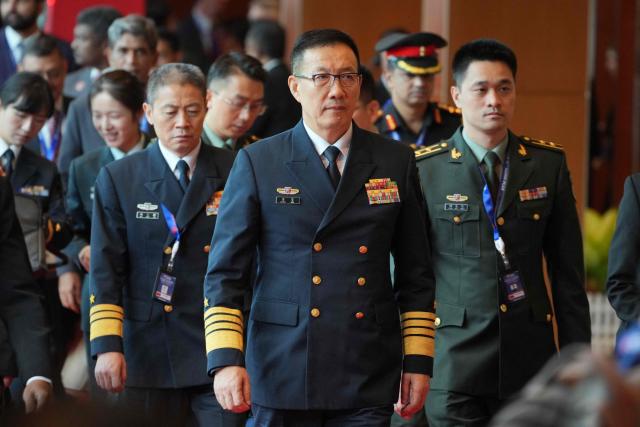 China's Defence Minister Dong Jun (C) walks to attend a ministerial lunch at the Association of Southeast Asian Nations (ASEAN) Defence Ministers' Meeting in Kuala Lumpur on November 1, 2025. (Photo by Dita ALANGKARA / POOL / AFP)