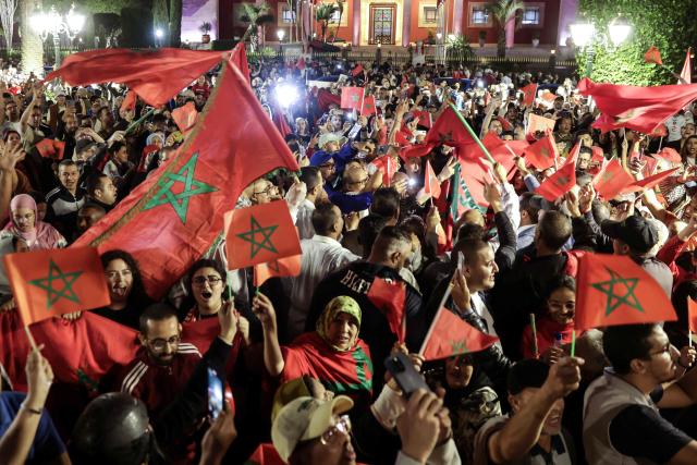 Moroccans celebrate the decision of the UN Security Council, which expressed its support for Morocco’s autonomy plan for Western Sahara — a territory that has been disputed for half a century between Rabat and the independence-seeking Polisario Front, backed by Algeria, in the city of Rabat on Rabat, late on October 31, 2025. The UN Security Council voted on October 31, in favor of a resolution backing Morocco's autonomy plan for Western Sahara as the "most feasible" solution for the disputed territory, triggering celebrations in Rabat but angering Algeria. (Photo by Abdel Majid BZIOUAT / AFP)